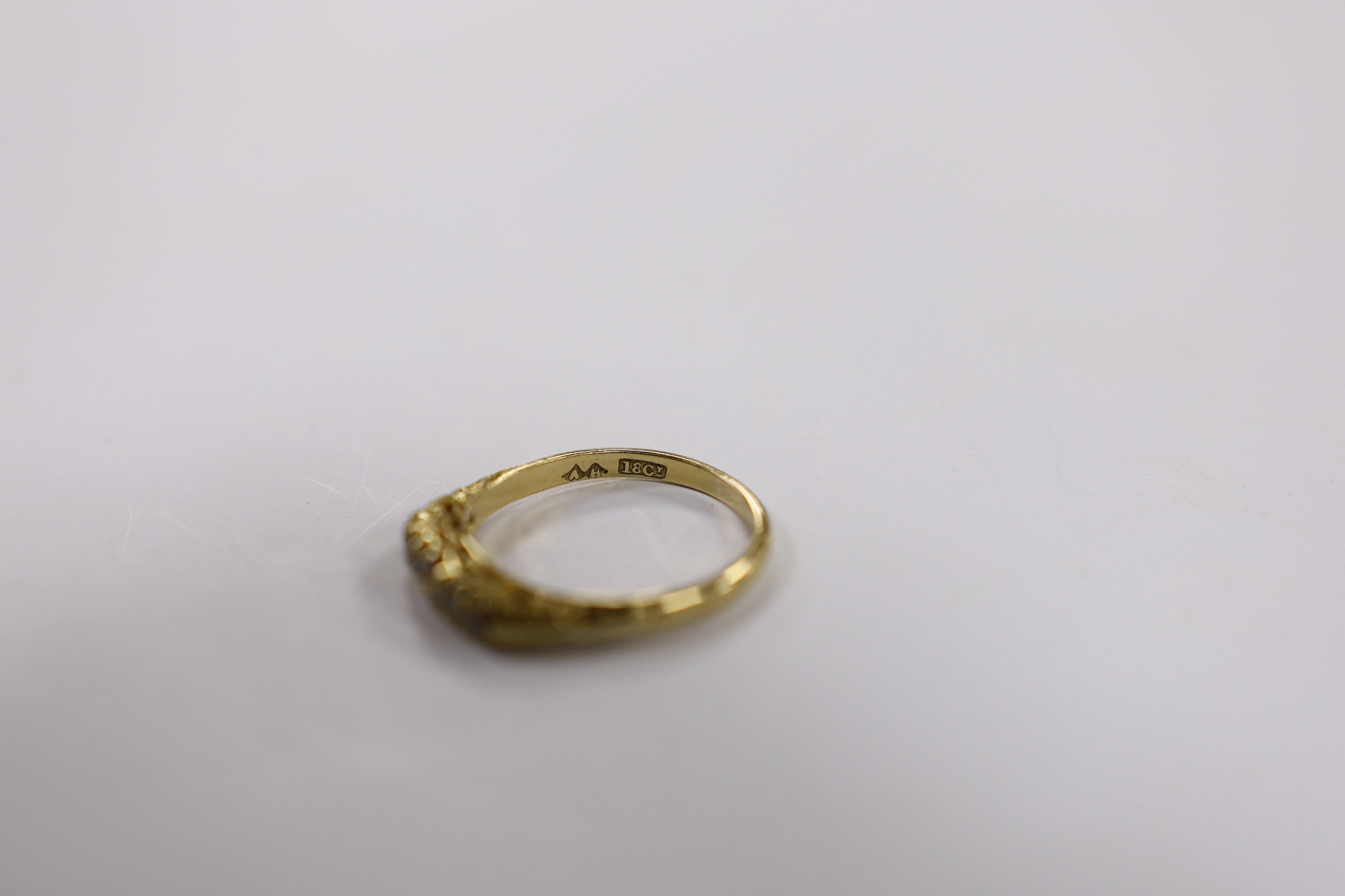 An 18ct and graduated five stone diamond set half hoop ring, size P/Q, gross weight 3.7 grams.